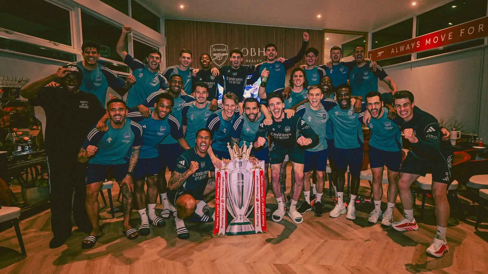 Arsenal squad pose with the Premier League trophy